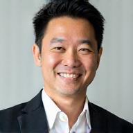 Headshot of Taro Yamamoto, a distinguished man with short dark hair, smiling warmly.